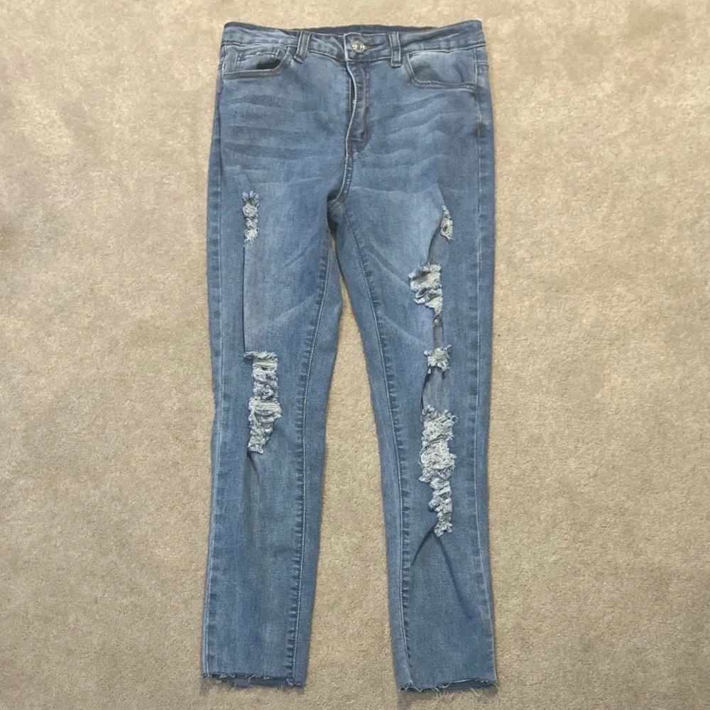 High Waisted Ripped Raw Hem Light Wash Skinny Jeans